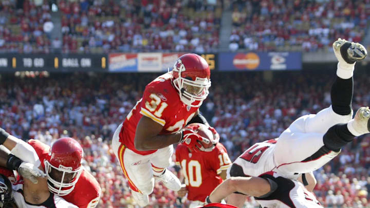 Oct 24, 2004; Kansas City, MO,  USA; Kansas City Chiefs running back #31 Priest Holmes flies over the Atlanta Falcons defensive line for his 4th touchdown of the 1st half at Arrowhead Stadium. Mandatory Credit: Photo By Jason Parkhurst-Imagn Images Copyright (c) 2004 Jason Parkhurst