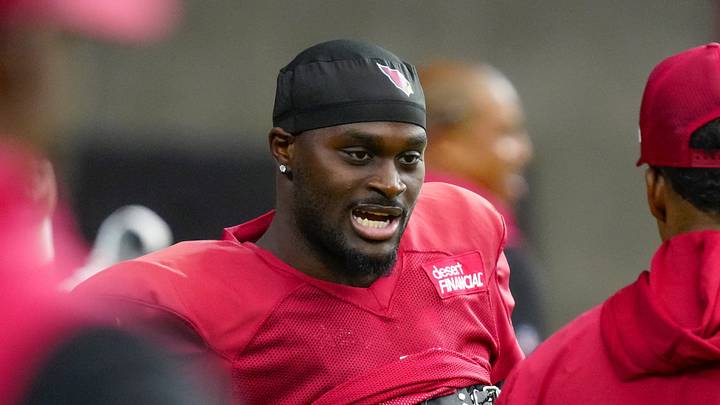 Cardinals running back Jeremiyah Love (4) talks with coaches during training camp at State Farm Stadium in Glendale on July 28, 2026.