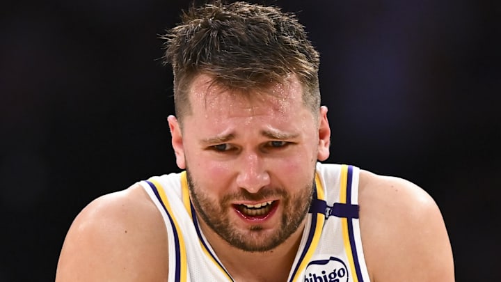 Mar 22, 2025; Los Angeles, California, USA; Los Angeles Lakers guard Luka Doncic (77) reacts to a call from referee Courtney Kirkland (61) against the Chicago Bulls during the second half at Crypto.com Arena. Mandatory Credit: Jonathan Hui-Imagn Images