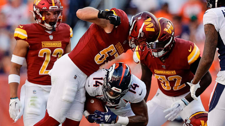 Sep 17, 2023; Denver, Colorado, USA; Washington Commanders linebacker Cody Barton (57) attempts to rip the ball away from Denver Broncos wide receiver Courtland Sutton (14) after he was tackled by safety Kamren Curl (31) and linebacker Jamin Davis (52) as wide receiver Lil'Jordan Humphrey (17) looks on in the fourth quarter at Empower Field at Mile High. Mandatory Credit: Isaiah J. Downing-USA TODAY Sports Sep 17, 2023; Denver, Colorado, USA; Washington Commanders linebacker Cody Barton (57) attempts to rip the ball away from Denver Broncos wide receiver Courtland Sutton (14) after he was tackled by safety Kamren Curl (31) and linebacker Jamin Davis (52) as wide receiver Lil'Jordan Humphrey (17) looks on in the fourth quarter at Empower Field at Mile High. Mandatory Credit: Isaiah J. Downing-USA TODAY Sports