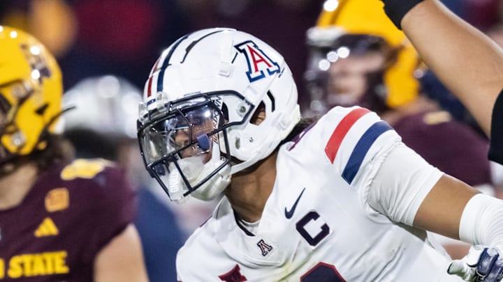 Nov 28, 2025; Tempe, Arizona, USA; Arizona Wildcats defensive back Genesis Smith (12) celebrates a fumble recovery with defensive lineman Leroy Palu (95) in the second half against the Arizona State Sun Devils in the 99th Territorial Cup at Mountain America Stadium. Mandatory Credit: Mark J. Rebilas-Imagn Images