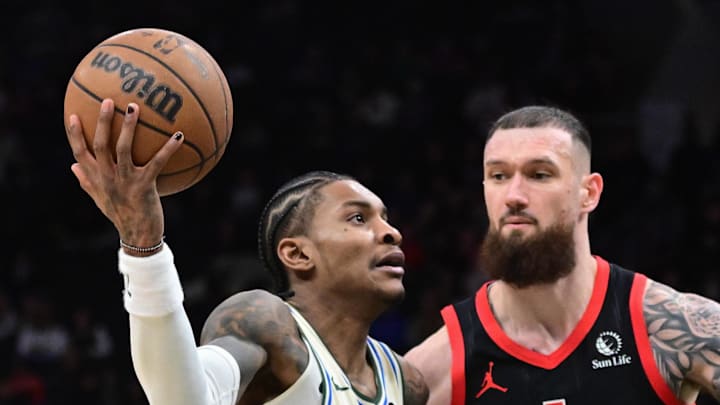 Milwaukee Bucks guard Kevin Porter Jr. drives against Toronto Raptors forward Sandro Mamukelashvili