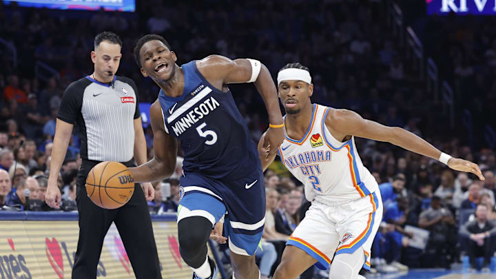 Feb 24, 2025; Oklahoma City, Oklahoma, USA; Minnesota Timberwolves guard Anthony Edwards (5) works to keep the ball inbounds as Oklahoma City Thunder guard Shai Gilgeous-Alexander (2) defends during the second half at Paycom Center. Mandatory Credit: Alonzo Adams-Imagn Images