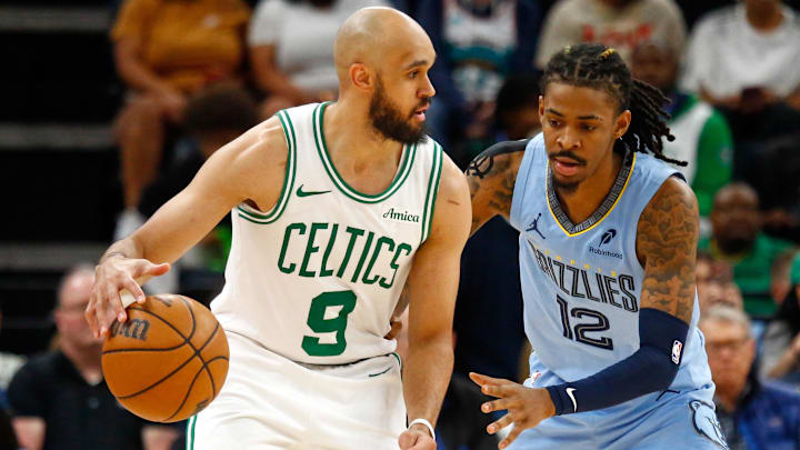 Mar 31, 2025; Memphis, Tennessee, USA; Boston Celtics guard Derrick White (9) dribbles as Memphis Grizzlies guard Ja Morant (12) defends during the third quarter at FedExForum. Mar 31, 2025; Memphis, Tennessee, USA; Boston Celtics guard Derrick White (9) dribbles as Memphis Grizzlies guard Ja Morant (12) defends during the third quarter at FedExForum.