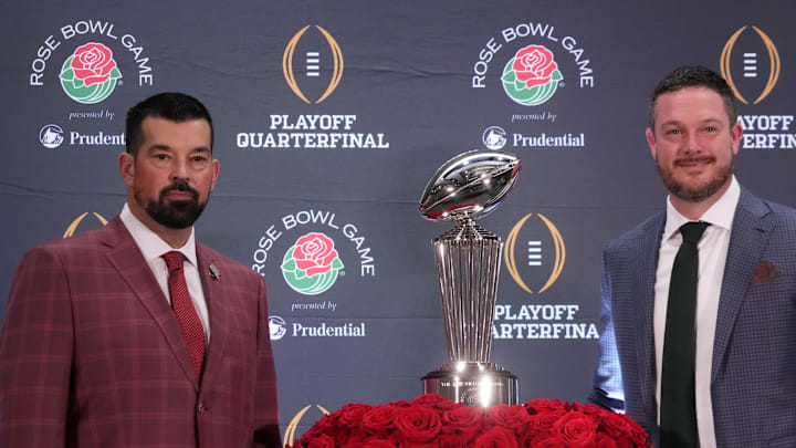 Dec 31, 2024; Los Angeles, California, USA; Ohio State Buckeyes head coach Ryan Day (left) and Oregon Ducks head coach Dan Lanning pose with the Leishman Trophy during the Rose Bowl head coaches press conference at Sheraton Grand LA. Mandatory Credit: Kirby Lee-Imagn Images