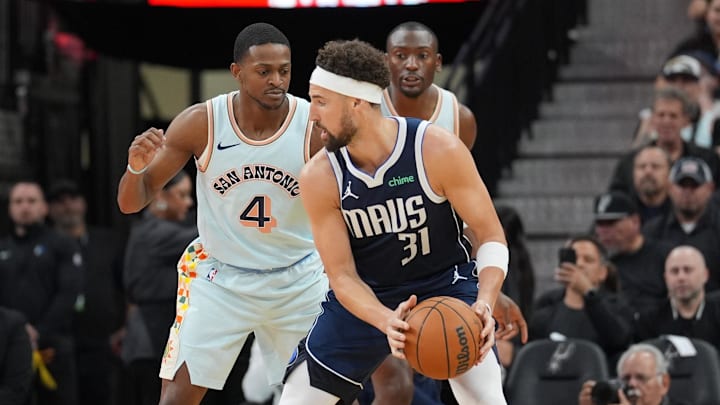 Mar 12, 2025; San Antonio, Texas, USA; San Antonio Spurs guard De'Aaron Fox (4) defends against Dallas Mavericks guard Klay Thompson (31) in the first half at Frost Bank Center. Mandatory Credit: Daniel Dunn-Imagn Images