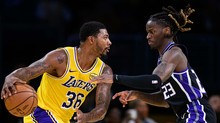 Oct 17, 2025; Los Angeles, California, USA; Los Angeles Lakers guard Marcus Smart (36) looks to drive past Sacramento Kings guard Keon Ellis (23)during the first half at Crypto.com Arena.