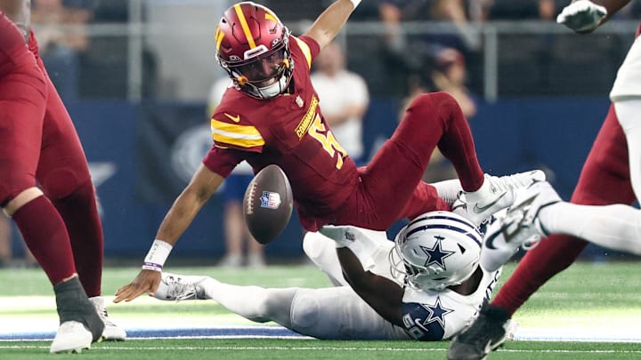 Washington Commanders quarterback Jayden Daniels fumbles the ball after a sack by Dallas Cowboys linebacker Shemar James