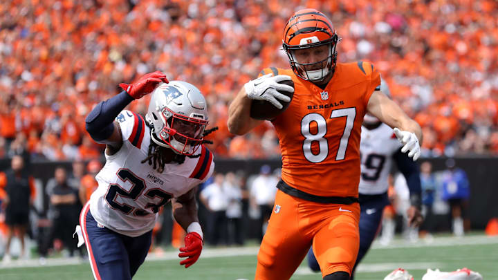 Sep 8, 2024; Cincinnati, Ohio, USA;  Cincinnati Bengals tight end Tanner Hudson (87) runs to the end zone, but eventually fumbles the ball as New England Patriots safety Kyle Dugger (23) causes the turnover during the second quarter at Paycor Stadium. Mandatory Credit: Joseph Maiorana-Imagn Images
