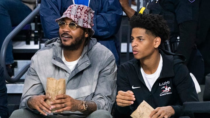 Carmelo Anthony and his son, Kiyan, watch the Don Bosco Prep Ironmen compete against the McEachern Indians in a game during the 50th annual City of Palms Classic at Suncoast Credit Union Arena in Fort Myers on Tuesday, Dec. 19, 2023. Kiyan Anthony and the Long Island Luthern Crusaders defeated Westminster Academy earlier in the day.