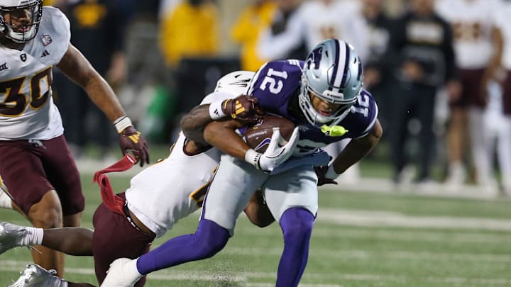 Nov 16, 2024; Manhattan, Kansas, USA; Kansas State Wildcats wide receiver Tre Spivey (12) is tackled by Arizona State Sun Devils defensive back Javan Robinson (12) during the fourth quarter at Bill Snyder Family Football Stadium. Mandatory Credit: Scott Sewell-Imagn Images