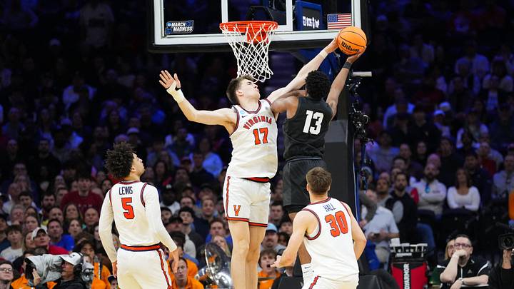 Mar 20, 2026; Philadelphia, PA, USA; Virginia Cavaliers center Johann Grünloh (17) blocks a lay up from Wright State Raiders guard Solomon Callaghan (13) during the second half during a first round game of the men's 2026 NCAA Tournament at Xfinity Mobile Arena. Mandatory Credit: Kyle Ross-Imagn Images Mar 20, 2026; Philadelphia, PA, USA; Virginia Cavaliers center Johann Grünloh (17) blocks a lay up from Wright State Raiders guard Solomon Callaghan (13) during the second half during a first round game of the men's 2026 NCAA Tournament at Xfinity Mobile Arena. Mandatory Credit: Kyle Ross-Imagn Images