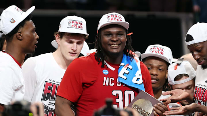 Mar 31, 2024; Dallas, TX, USA; North Carolina State Wolfpack forward DJ Burns Jr. (30) celebrates with the trophy after defeating the Duke Blue Devils in the finals of the South Regional of the 2024 NCAA Tournament at American Airlines Center. Mandatory Credit: Tim Heitman-Imagn Images