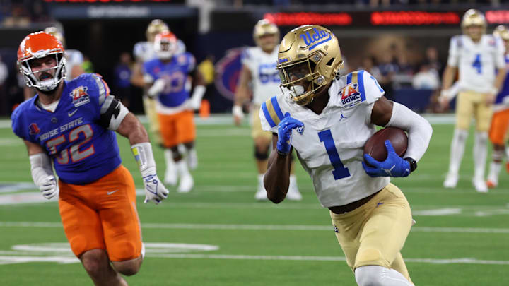 Dec 16, 2023; Inglewood, CA, USA;  UCLA Bruins wide receiver J. Michael Sturdivant (1) runs with the ball after catching a pass against Boise State Broncos linebacker DJ Schramm (52) during the third quarter of the LA Bowl at SoFi Stadium. Mandatory Credit: Kiyoshi Mio-Imagn Images