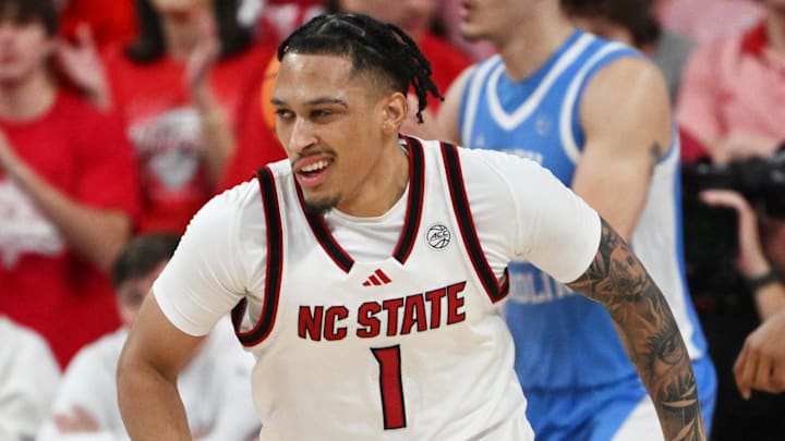 Feb 17, 2026; Raleigh, North Carolina, USA; NC State Wolfpack forward Darrion Williams (1) reacts after scoring against the North Carolina Tar Heels during the second half at Lenovo Center. Mandatory Credit: Zachary Taft-Imagn Images