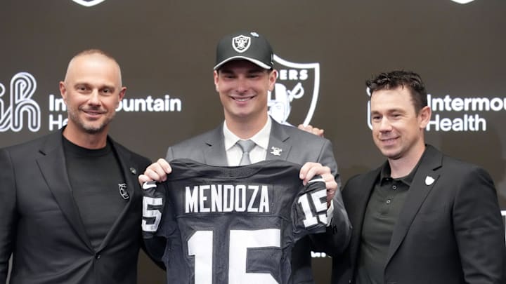 Apr 24, 2026; Henderson, NV, USA; Las Vegas Raiders quarterback Fernando Mendoza (center) poses with jersey with general manager John Spytek (left) and head coach Klint Kubiak  at introductory press conference at Intermountain Health Performance Center after being selected as the No. 1 pick in the 2026 NFL Draft. Mandatory Credit: Kirby Lee-Imagn Images