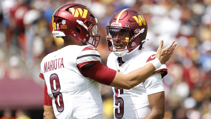 Sep 7, 2025; Landover, Maryland, USA; Washington Commanders quarterback Jayden Daniels (5) talks to Commanders quarterback Marcus Mariota (8) on the field during the first quarter against the New York Giants at Northwest Stadium. Mandatory Credit: Amber Searls-Imagn Images Sep 7, 2025; Landover, Maryland, USA; Washington Commanders quarterback Jayden Daniels (5) talks to Commanders quarterback Marcus Mariota (8) on the field during the first quarter against the New York Giants at Northwest Stadium. Mandatory Credit: Amber Searls-Imagn Images