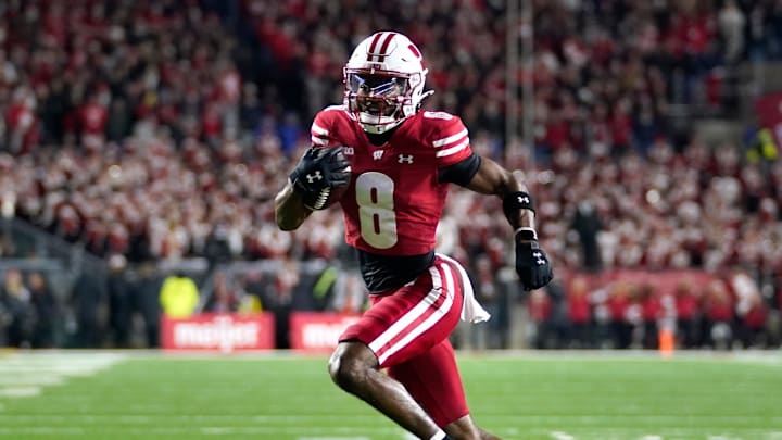 Nov 22, 2025; Madison, Wisconsin, USA; Wisconsin Badgers wide receiver Vinny Anthony II (8) runs the ball for a touchdown during the first quarter against the Illinois Fighting Illini at Camp Randall Stadium.