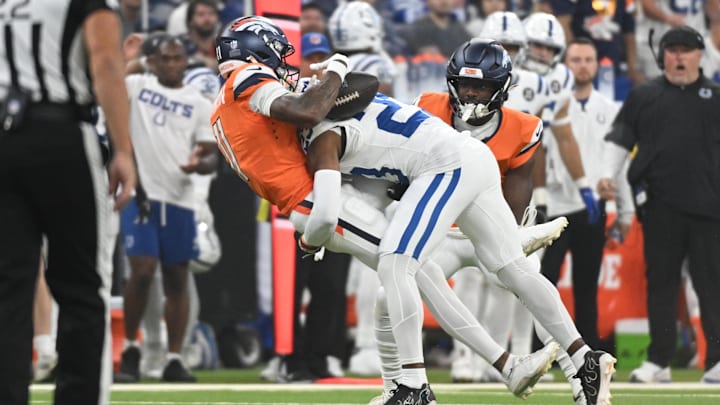 Sep 14, 2025; Indianapolis, Indiana, USA; Indianapolis Colts cornerback Kenny Moore II (23) tackles Denver Broncos wide receiver Troy Franklin (11) during the second quarter at Lucas Oil Stadium. Mandatory Credit: Robert Goddin-Imagn Images