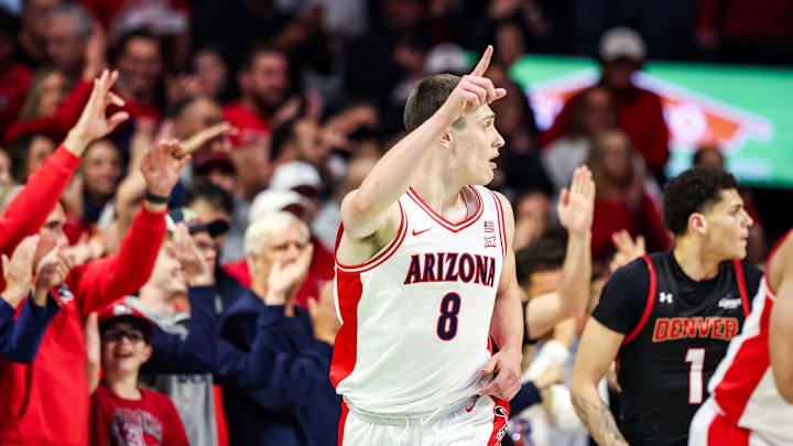 Nov 24, 2025; Tucson, Arizona, USA; Arizona Wildcats forward Ivan Kharchenkov (8) points after me makes a three pointer during the first half of the game against the Denver Pioneers at McKale Memorial Center. Mandatory Credit: Aryanna Frank-Imagn Images