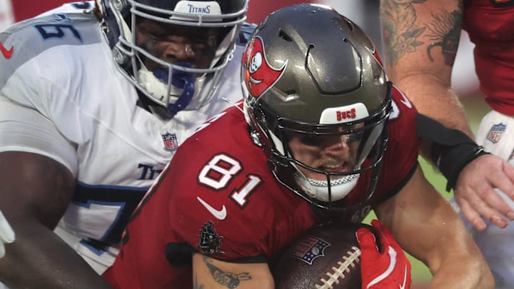 Aug 9, 2025; Tampa, Florida, USA; Tennessee Titans defensive tackle Isaiah Raikes (76) tackles Tampa Bay Buccaneers wide receiver Ryan Miller (81) during the first half at Raymond James Stadium. Mandatory Credit: Kim Klement Neitzel-Imagn Images