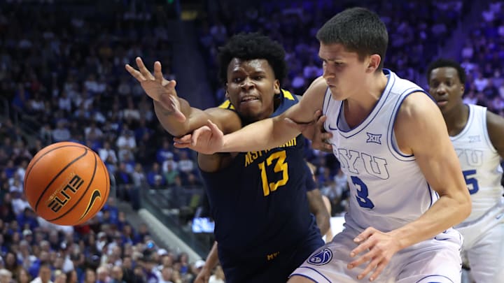 Mar 1, 2025; Provo, Utah, USA; West Virginia Mountaineers forward Amani Hansberry (13) and Brigham Young Cougars guard Egor Demin (3) battle for a loose ball during the first half at Marriott Center. Mandatory Credit: Rob Gray-Imagn Images