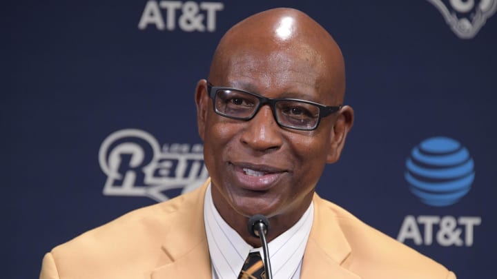 Former SMU Mustangs running back Eric Dickerson wears a Pro Football Hall of Fame gold jacket during a press conference after signing a one-day contract to retire as a member of the Los Angeles Rams at Cal Lutheran University.