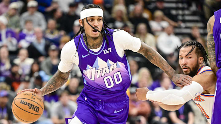 Nov 23, 2024; Salt Lake City, Utah, USA; Utah Jazz guard Jordan Clarkson (00) dribbles the ball against New York Knicks guard Jalen Brunson (11) after a screen by Utah forward/center John Collins (20) during the second half at the Delta Center. Mandatory Credit: Christopher Creveling-Imagn Images