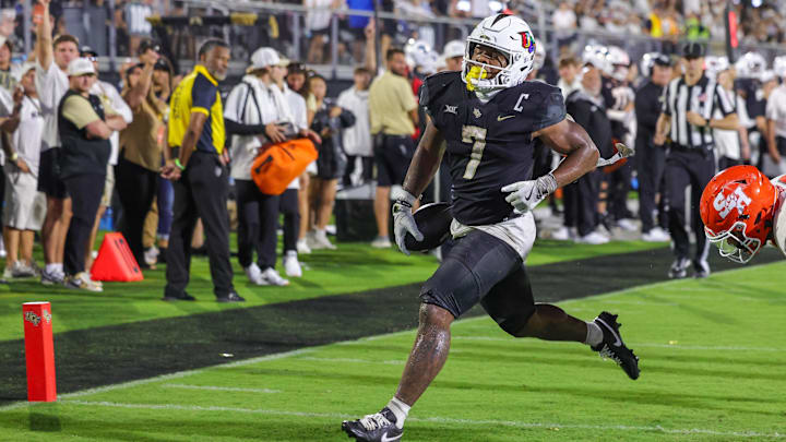 Sep 7, 2024; Orlando, Florida, USA; UCF Knights running back RJ Harvey (7) scores a touchdown during the second quarter against the Sam Houston State Bearkats at FBC Mortgage Stadium. 