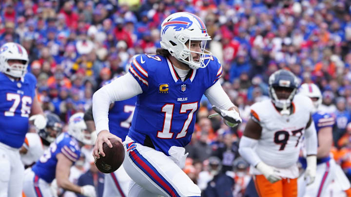 Buffalo Bills quarterback Josh Allen runs with the ball during a game.