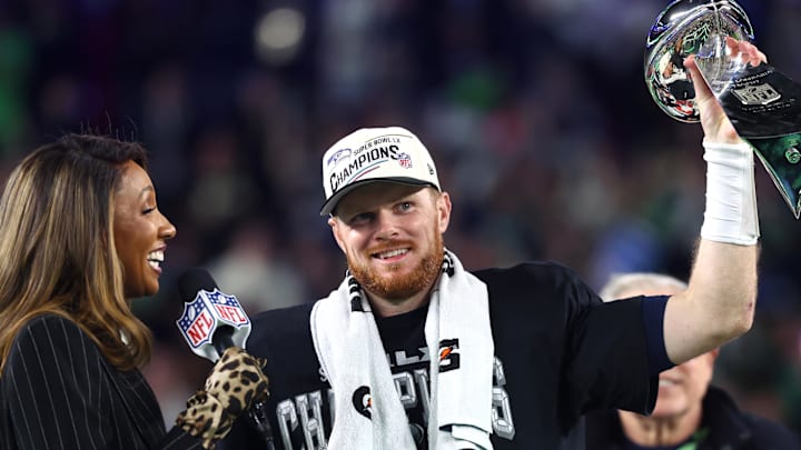 Feb 8, 2026; Santa Clara, CA, USA; Seattle Seahawks quarterback Sam Darnold (14) celebrates with the Vince Lombardi trophy on the podium after defeating the New England Patriots in Super Bowl LX at Levi's Stadium. 