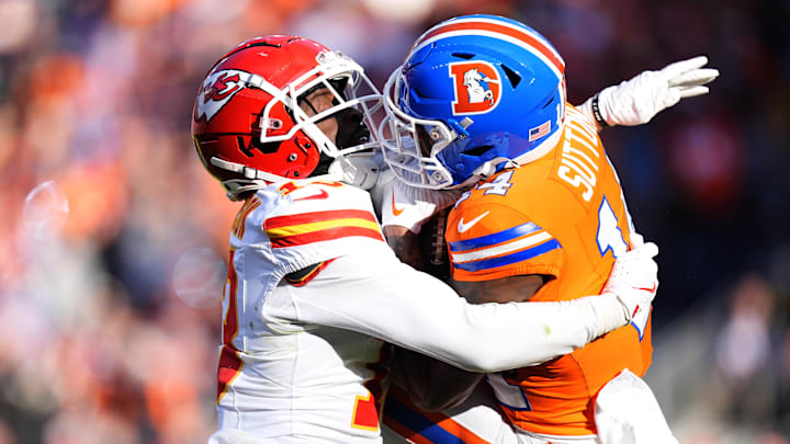 Jan 5, 2025; Denver, Colorado, USA; Denver Broncos wide receiver Courtland Sutton (14) catches a pass against Kansas City Chiefs cornerback Nazeeh Johnson (13) in the first quarter at Empower Field at Mile High. Mandatory Credit: Ron Chenoy-Imagn Images
