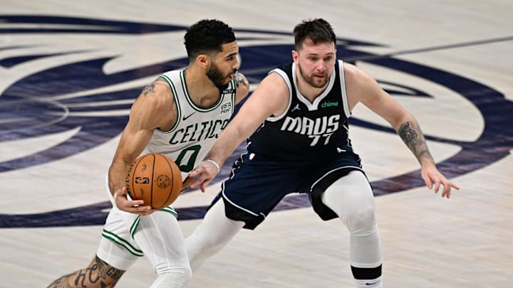 Jun 14, 2024; Dallas, Texas, USA; Boston Celtics forward Jayson Tatum (0) dribbles against Dallas Mavericks guard Luka Doncic (77) during the first half of game four of the 2024 NBA Finals at American Airlines Center. Mandatory Credit: Jerome Miron-Imagn Images