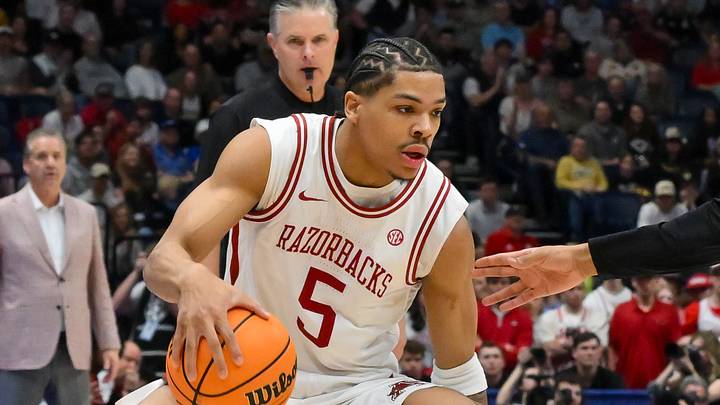 Mar 15, 2026; Nashville, TN, USA; Arkansas Razorbacks guard Darius Acuff Jr. (5) drives to the basket past Vanderbilt Commodores forward Devin McGlockton (99) during the first half during the men's SEC Conference Tournament Championship at Bridgestone Arena. Mandatory Credit: Steve Roberts-Imagn Images