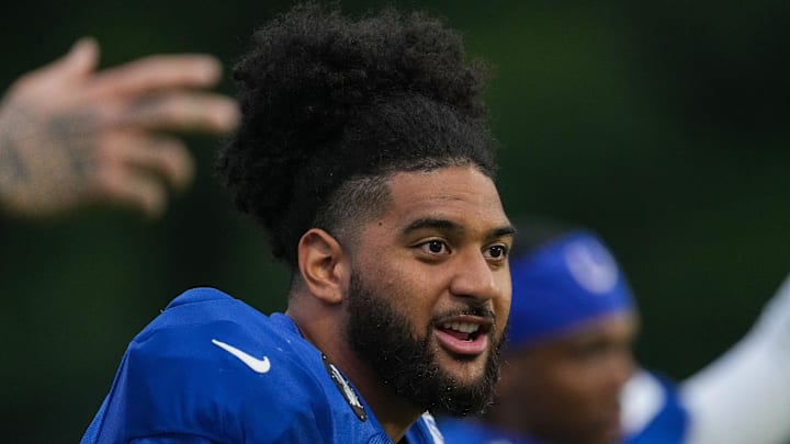 Indianapolis Colts defensive end JT Tuimoloau sings while warming up