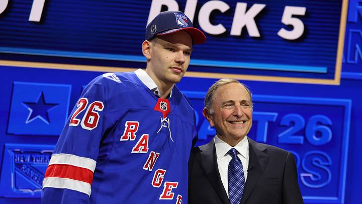 Jun 26, 2026; Buffalo, New York, USA; Alberts Smits reacts beside NHL commissioner Gary Bettman after being selected with the fifth pick in the first round of the 2026 NHL Draft by the New York Rangers at KeyBank Center. Mandatory Credit: Timothy T. Ludwig-Imagn Images