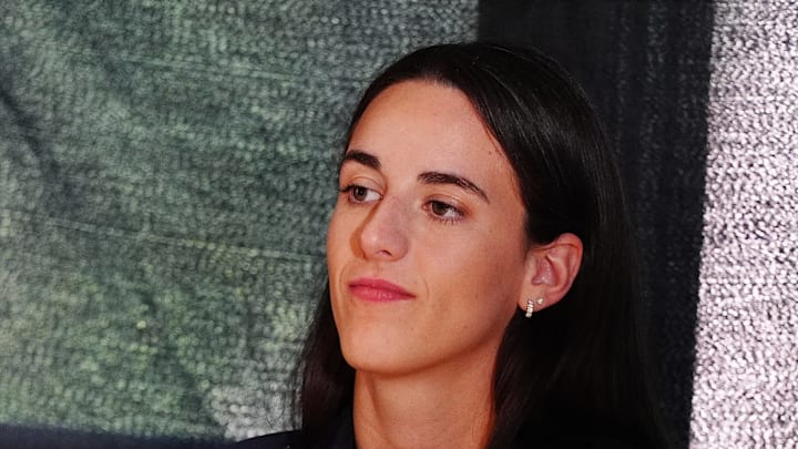 Caitlin Clark waits to speak at a press conference.