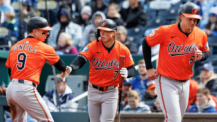 Apr 5, 2025; Kansas City, Missouri, USA; Baltimore Orioles second baseman Jackson Holliday (7) reacts with Baltimore Orioles outfielder Tyler O'Neill (9) and first baseman Ryan Mountcastle (6) after scoring during the second inning against the Kansas City Royals at Kauffman Stadium