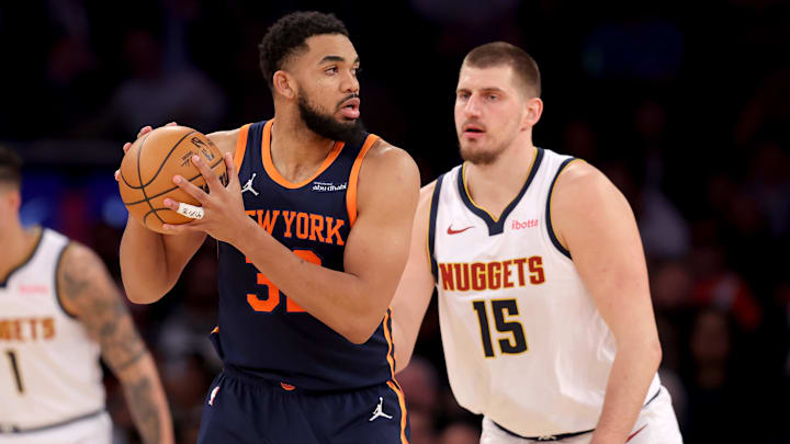 Jan 29, 2025; New York, New York, USA; New York Knicks center Karl-Anthony Towns (32) controls the ball against Denver Nuggets center Nikola Jokic (15) during the third quarter at Madison Square Garden. Mandatory Credit: Brad Penner-Imagn Images
