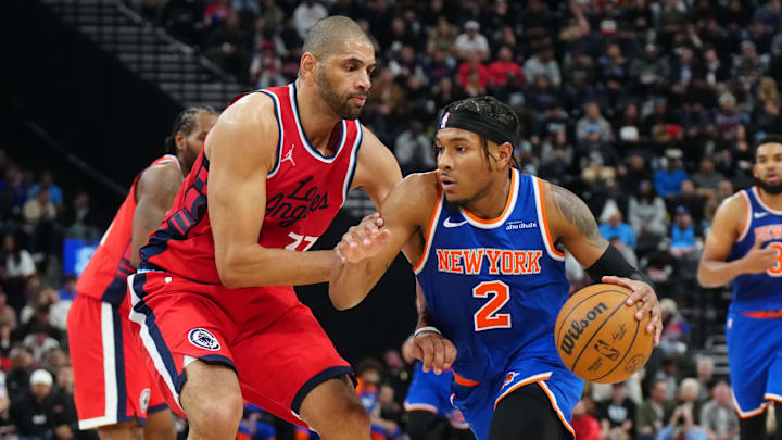 Mar 7, 2025; Inglewood, California, USA; New York Knicks guard Miles McBride (2) dribbles the ball against LA Clippers forward Nicolas Batum (33) in the second half at Intuit Dome. Mandatory Credit: Kirby Lee-Imagn Images