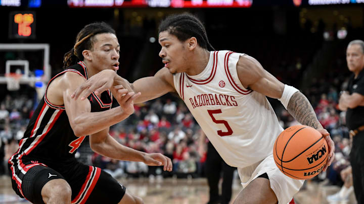 Dec 20, 2025; Newark, New Jersey, USA; Arkansas Razorbacks guard Darius Acuff Jr. (5) tries to drive past Houston Cougars guard Kingston Flemings (4) during the first half at Prudential Center. Mandatory Credit: John Jones-Imagn Images