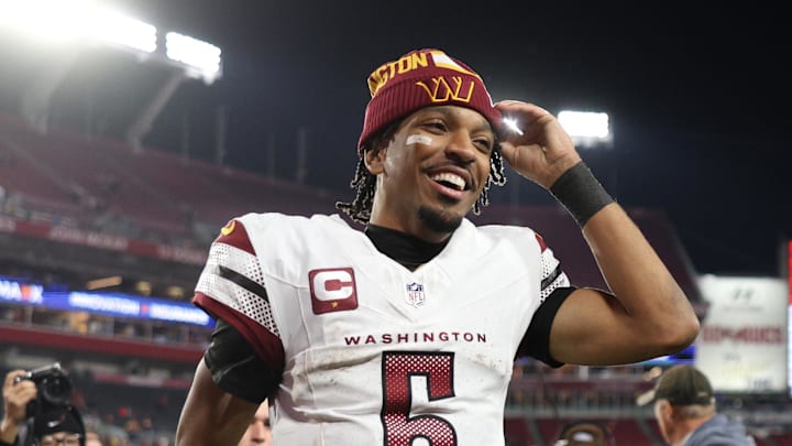 Jan 12, 2025; Tampa, Florida, USA; Washington Commanders quarterback Jayden Daniels (5) celebrates after winning a NFC wild card playoff against the Tampa Bay Buccaneers at Raymond James Stadium. Mandatory Credit: Nathan Ray Seebeck-Imagn Images