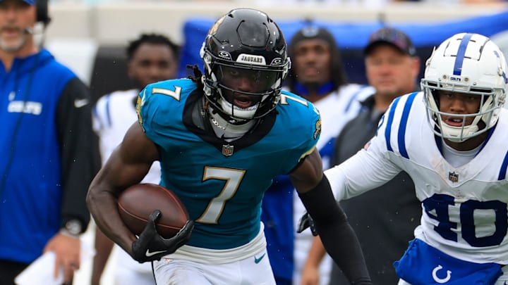 Jacksonville Jaguars wide receiver Brian Thomas Jr. (7) rushes for yards against Indianapolis Colts cornerback Jaylon Jones (40) during the fourth quarter of an NFL football matchup Sunday, Oct. 6, 2024 at EverBank Stadium in Jacksonville, Fla. The play was called back on a offensive facemask penalty. The Jaguars edged the Colts on a field goal 37-34. [Corey Perrine/Florida Times-Union]