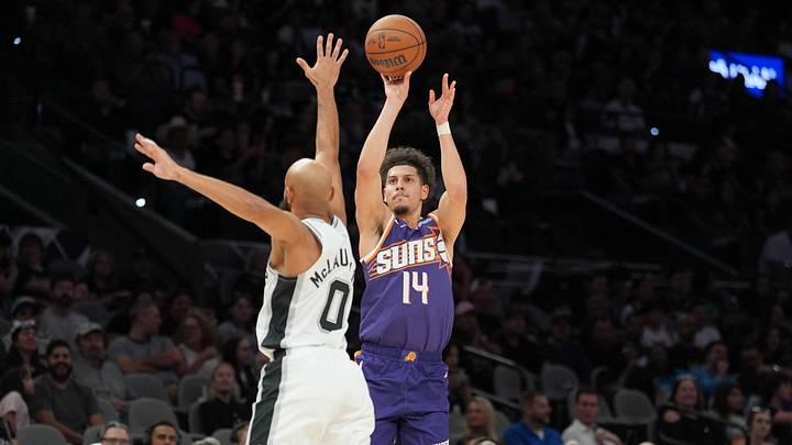 Oct 14, 2026; San Antonio, Texas, USA; Phoenix Suns guard Koby Brea (14) shoots over San Antonio Spurs guard Jordan McLaughlin (0) in the second half at Frost Bank Center. Mandatory Credit: Daniel Dunn-Imagn Images Oct 14, 2026; San Antonio, Texas, USA; Phoenix Suns guard Koby Brea (14) shoots over San Antonio Spurs guard Jordan McLaughlin (0) in the second half at Frost Bank Center. Mandatory Credit: Daniel Dunn-Imagn Images