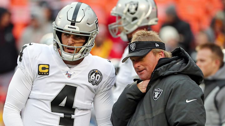 Dec 1, 2019; Kansas City, MO, USA; Oakland Raiders head coach Jon Gruden talks with quarterback Derek Carr (4) before the game against the Kansas City Chiefs at Arrowhead Stadium. Mandatory Credit: Jay Biggerstaff-Imagn Images