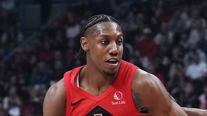Toronto Raptors forward RJ Barrett controls the ball as  Cleveland Cavaliers guard James Harden tries to defend.