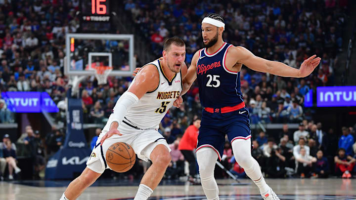 Apr 24, 2025; Inglewood, California, USA; Denver Nuggets center Nikola Jokic (15) moves to the basket against Los Angeles Clippers guard Ben Simmons (25) during the first half of game three in the first round for the 2024 NBA Playoffs at Intuit Dome. Mandatory Credit: Gary A. Vasquez-Imagn Images