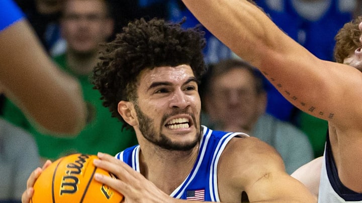 Feb 24, 2026; South Bend, Indiana, USA; Duke Blue Devils forward Cameron Boozer (12) works against Notre Dame Fighting Irish forward Carson Towt (33) during the first half at Purcell Pavilion at the Joyce Center. Mandatory Credit: Michael Caterina-Imagn Images