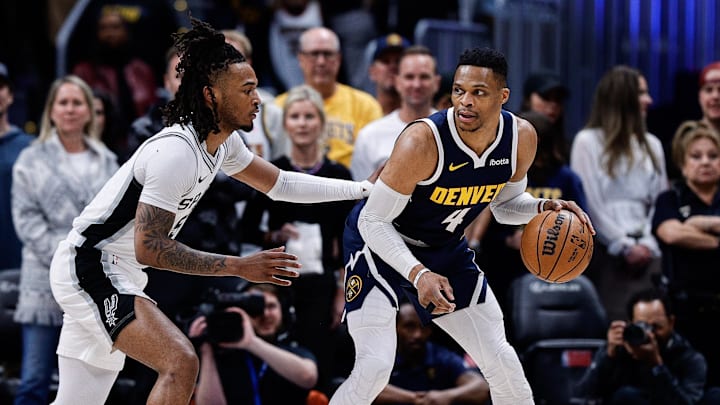 Apr 2, 2025; Denver, Colorado, USA; Denver Nuggets guard Russell Westbrook (4) controls the ball as San Antonio Spurs guard Stephon Castle (5) guards in the first quarter at Ball Arena. Apr 2, 2025; Denver, Colorado, USA; Denver Nuggets guard Russell Westbrook (4) controls the ball as San Antonio Spurs guard Stephon Castle (5) guards in the first quarter at Ball Arena.