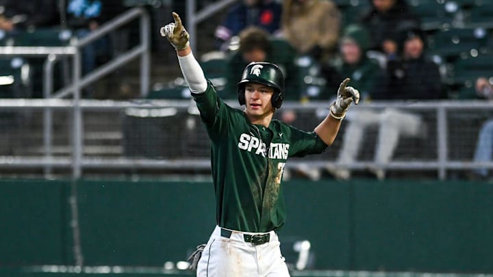 Michigan State's Randy Seymour, right, celebrates after scoring against the Lugnuts in the third inning on Tuesday, April 4, 2023, during the Crosstown Showdown at Jackson Field in Lansing.

230404 Msu Lugnuts Bsball 132a